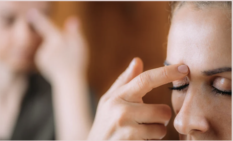 Picture of lady tapping using EFT (Emotional Freedom Techniques)