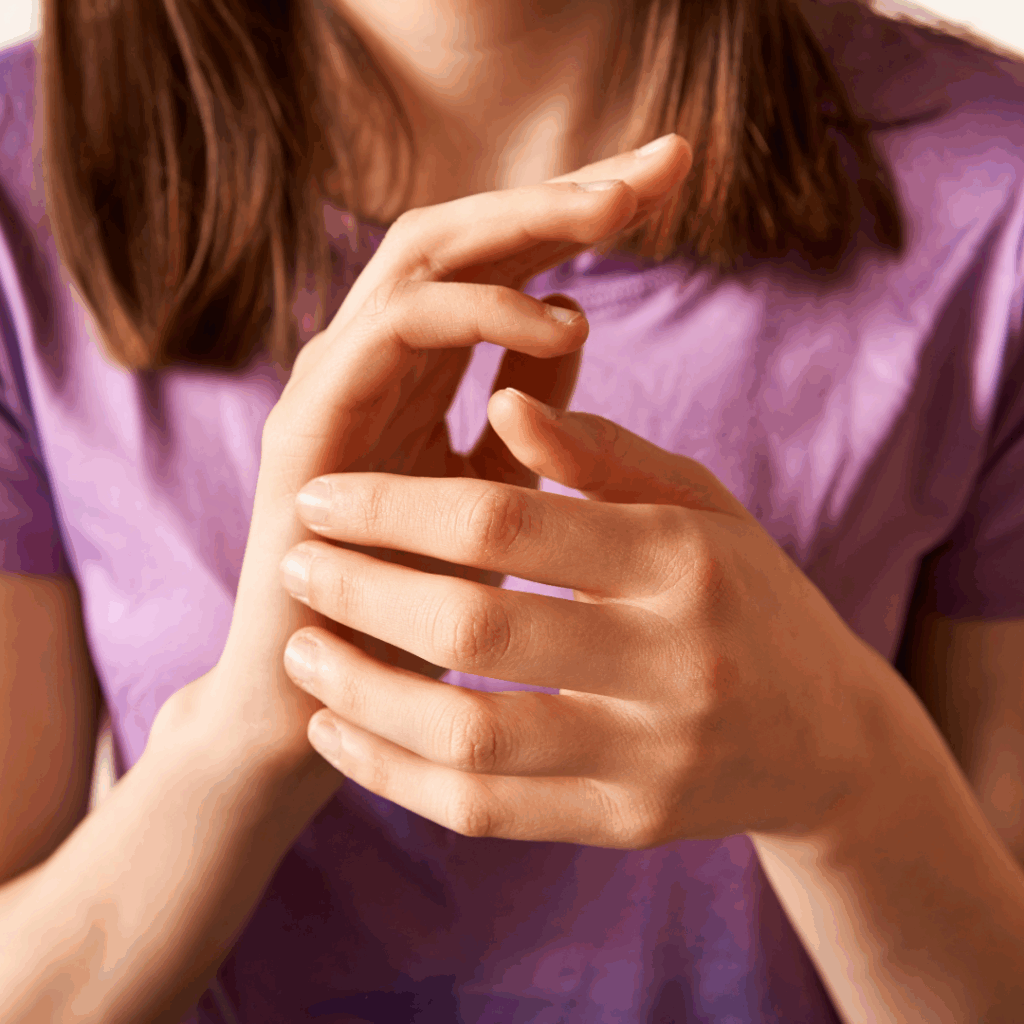 Woman holding fingers against EFT tapping point